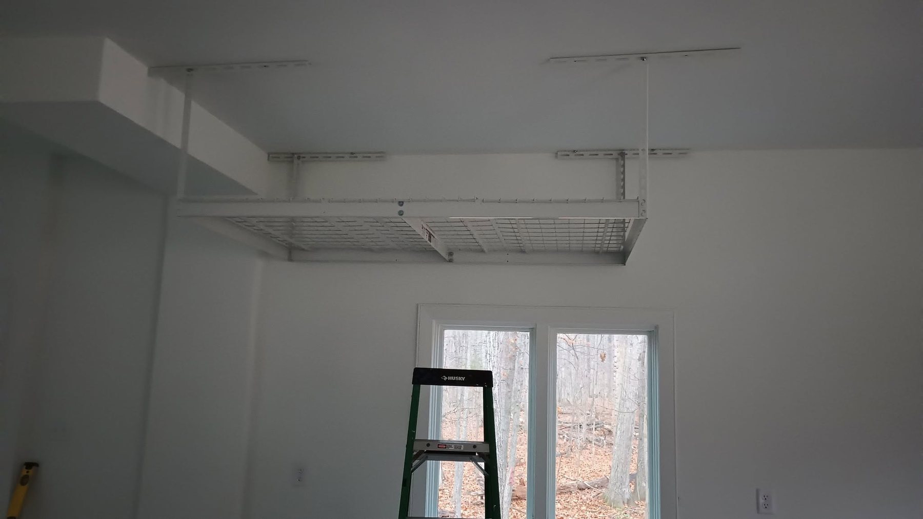 Overhead storage shelving installed in a garage